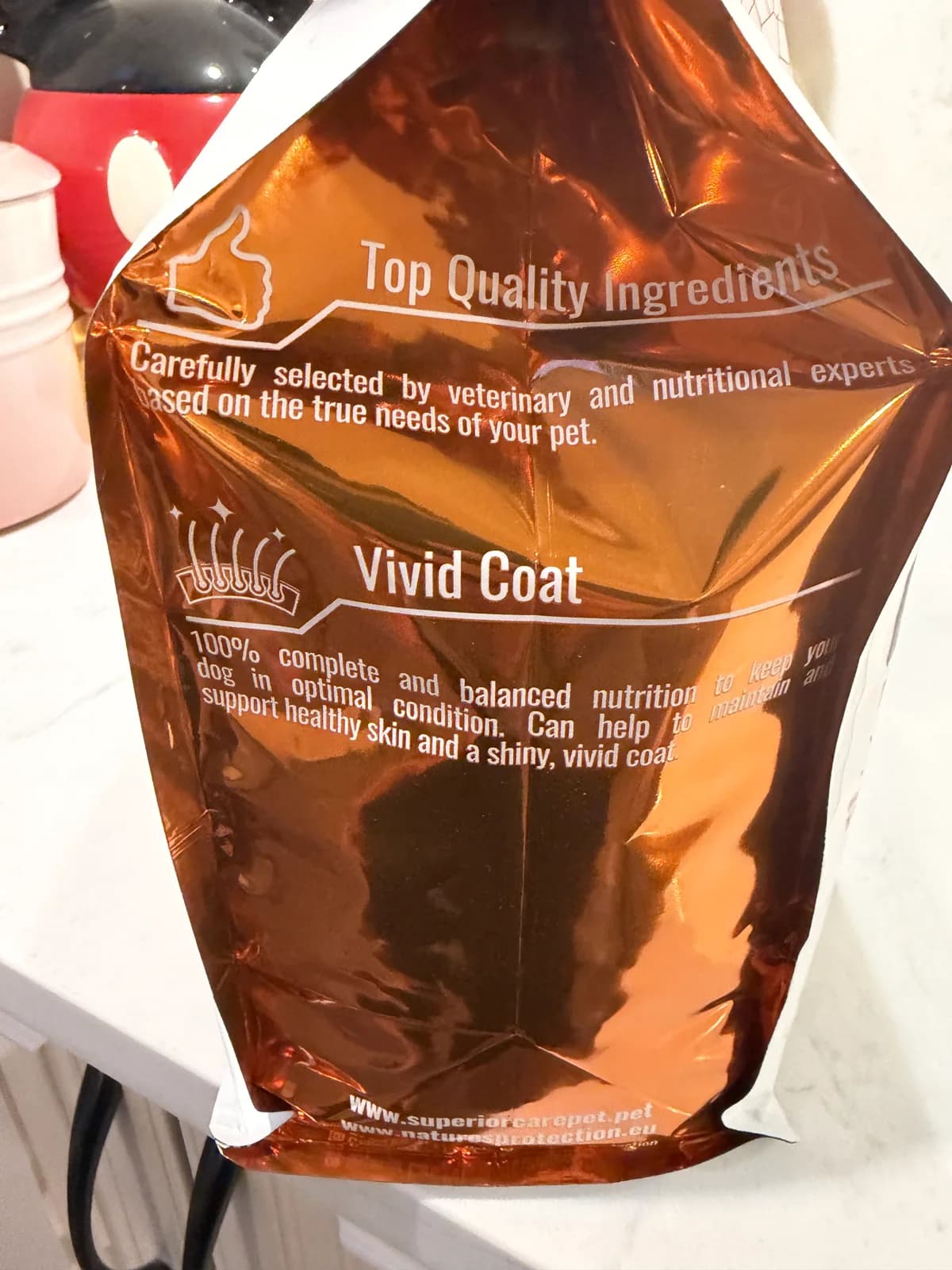Salmon, krill, and vivid-coat callouts on a Nature's Protection Red Coat food bag