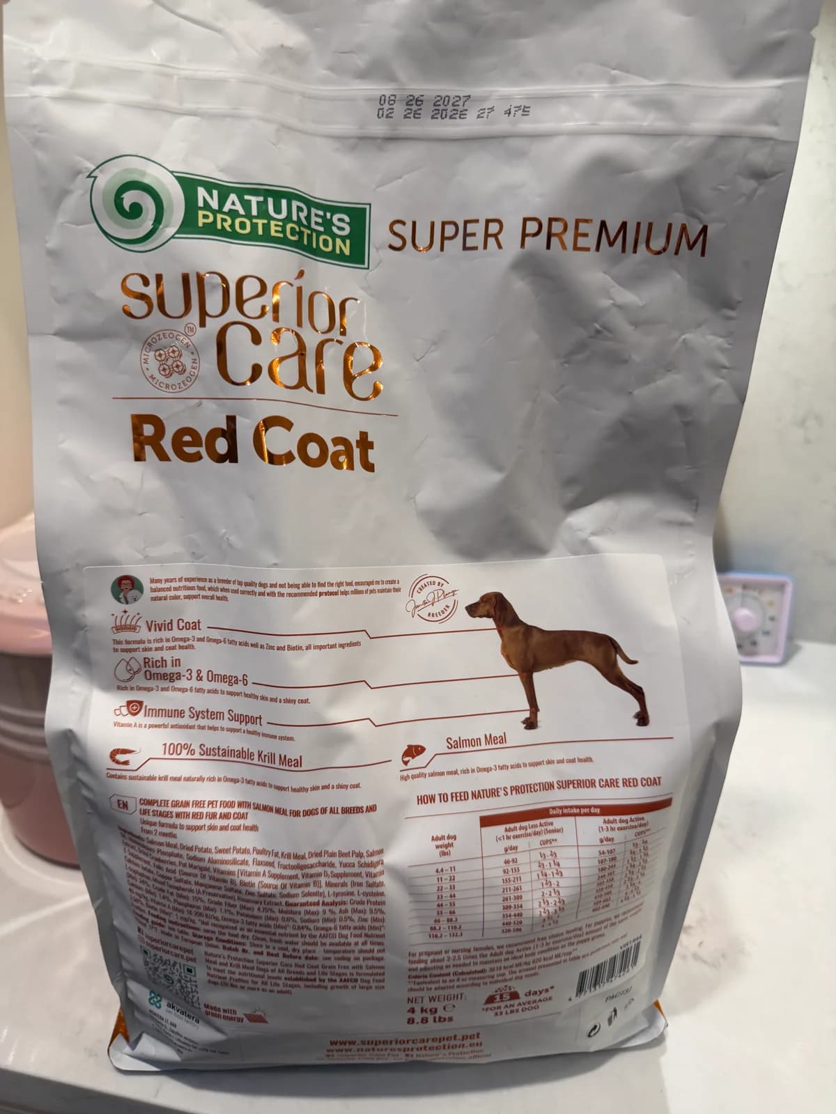 Ingredient list and feeding chart on a Nature's Protection Red Coat dog food bag