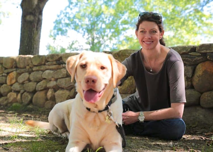 Photo of WellPet CEO Camelle Kent with her Labrador Retriever dog