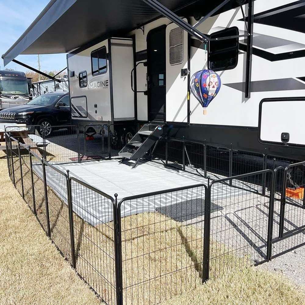 Black FXW Rollick playpen arranged beside an RV