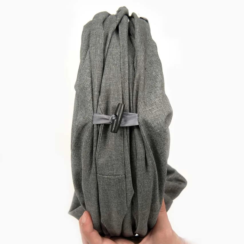 Hand holding a gray Catit Vesper tunnel folded and secured with a strap