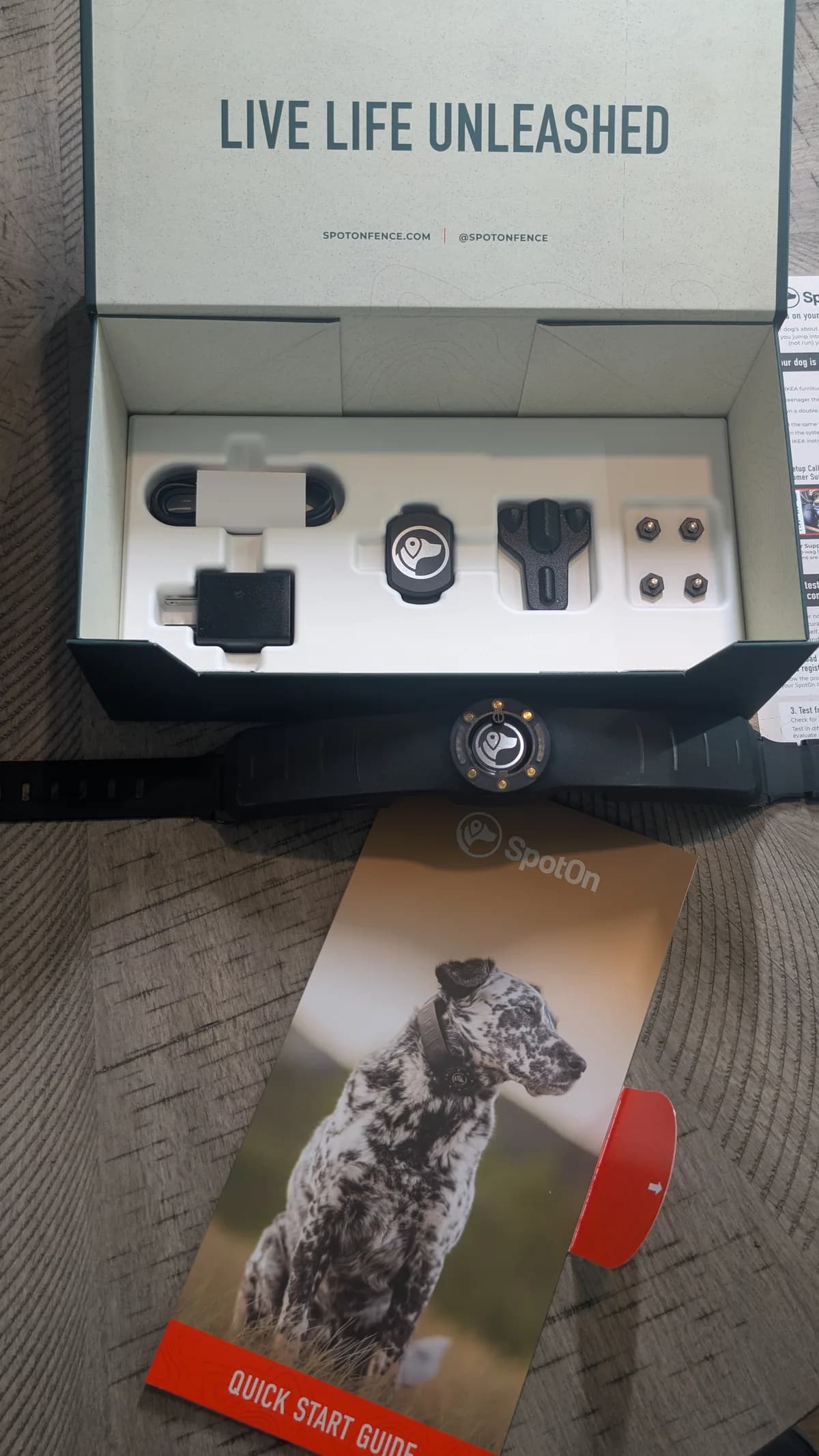 The SpotOn dog collar unboxed: the collar, charging cradle, fit tool, contact points, and Quick Start Guide in the box.