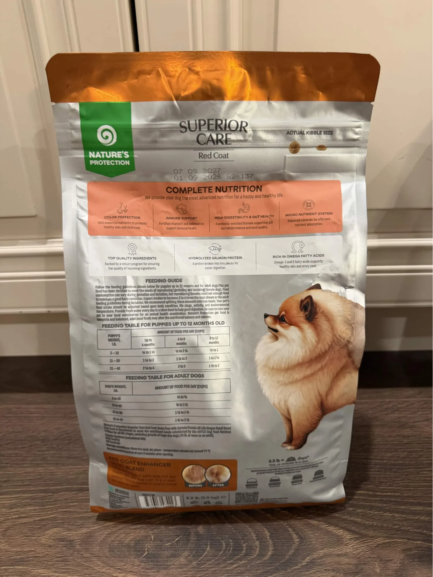 Back of a Nature's Protection Superior Care Red Coat small breed dog food bag showing benefits and feeding tables