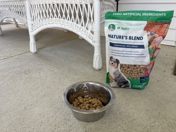 Dr. Marty Pets Nature’s Blend dog food bag beside a bowl of freeze-dried kibble.