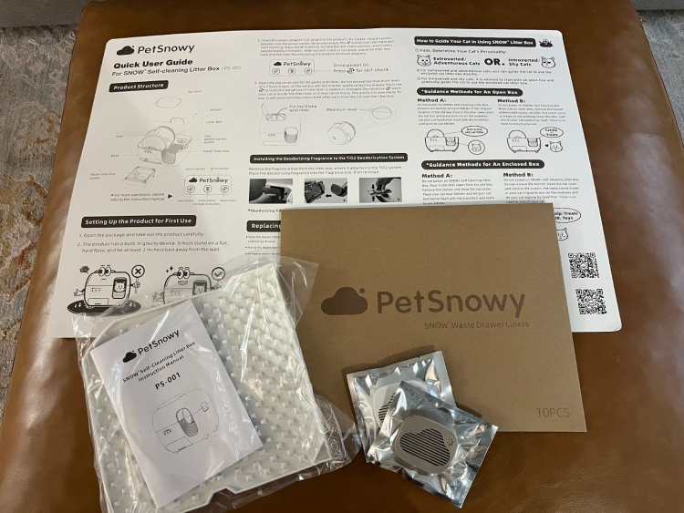 PetSnowy Litter Box user guide and accessories included in the package.