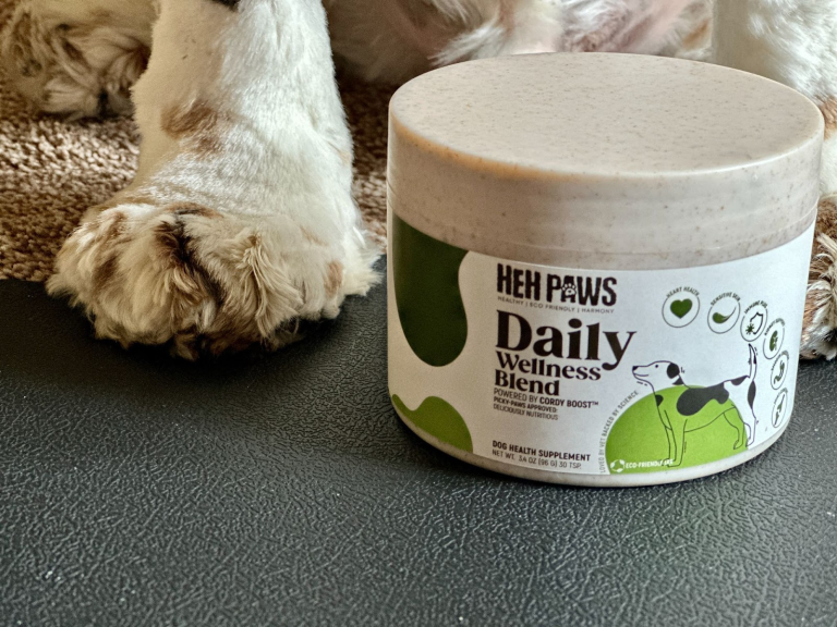 HEH Paws Daily Wellness Blend supplement jar beside dog paw