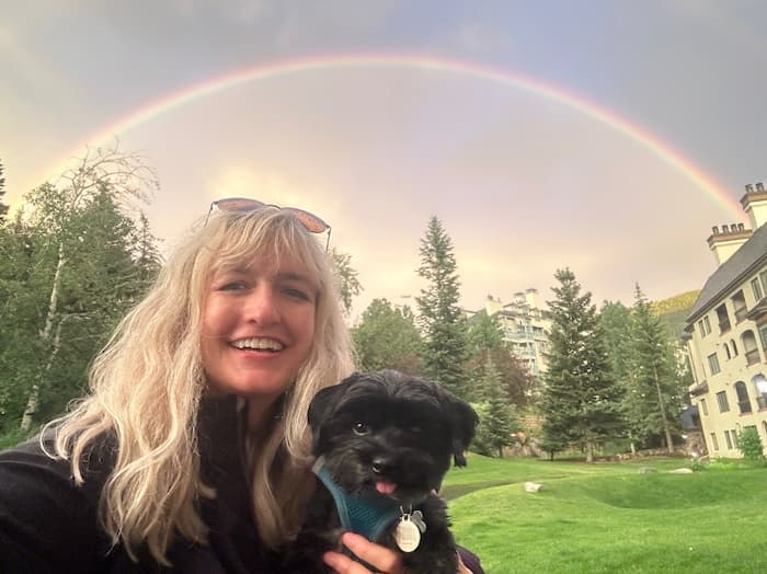 Woman with dog and rainbow